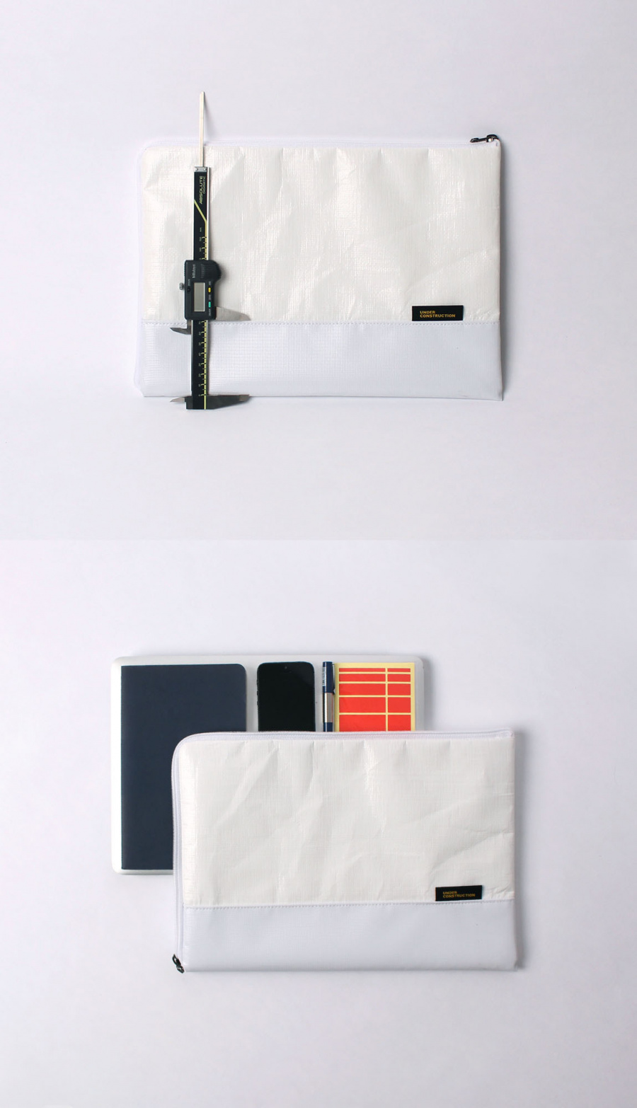 언더 컨스트(UNDER CONST.) 노트북파우치 화이트